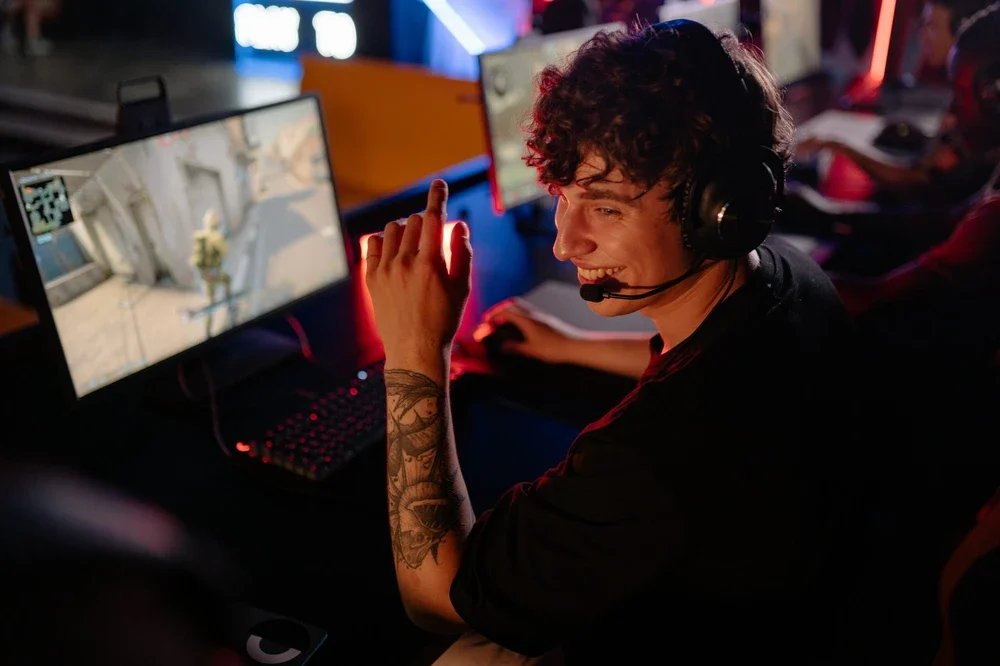 Gamer smiling at his friend at a LAN party