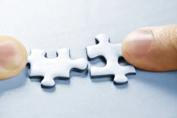 Puzzle pieces being put together