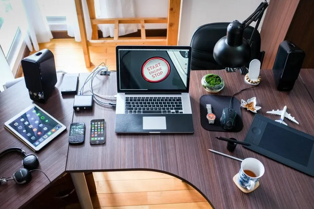 office desk with technical utilities, laptops, tablets, iphones.