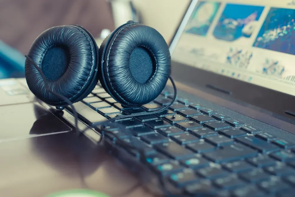 Scenic view of headphones and laptop close up