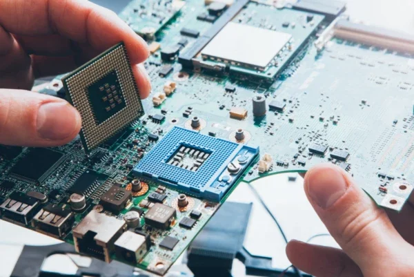 Technician replacing a CPU chip
