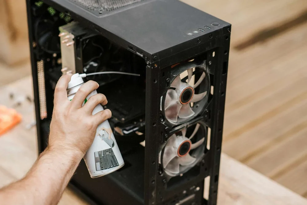 Man cleaning computer system unit