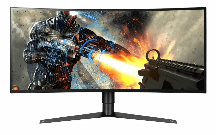 A curved flat screen tv with a stand holding it up and an action game displayed on the screen
